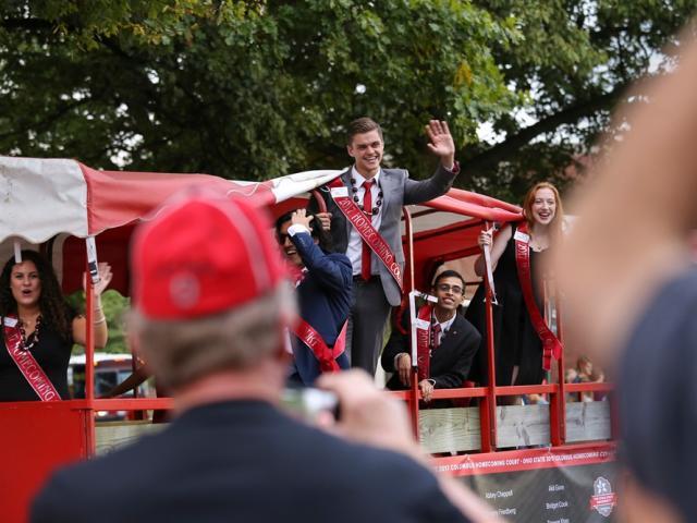 A member of the Homecoming Court waves at spectators during a Homecoming Parade