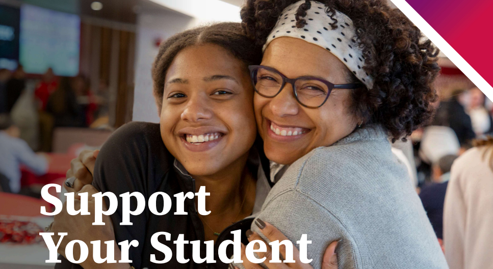 A parent and student hug while smiling at the camera