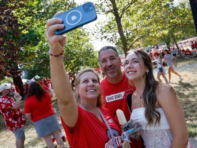 A family takes an overhead selfie on the South Oval at Buckeye Family and Football Tailgate 2024