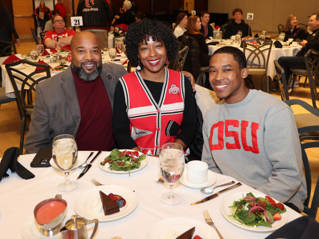 A family sitting at a table during Legacy Dinner 2024