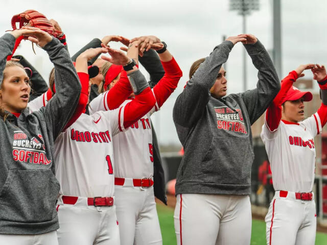 Players on Ohio State's softball team make an "O" shape with their arms